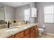 Bathroom with double vanity, granite countertop, and ample cabinet space at 8788 Fetterbush Ct, Brooksville, FL 34613