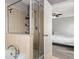 Bathroom featuring soaking tub with shower, glass door, and ensuite bedroom access at 8788 Fetterbush Ct, Brooksville, FL 34613