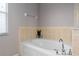 Bathroom featuring a soaking tub with decorative accents and tile surround at 8788 Fetterbush Ct, Brooksville, FL 34613