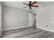 Spacious bedroom featuring wood-look floors and a ceiling fan at 8788 Fetterbush Ct, Brooksville, FL 34613
