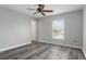 Bedroom with a ceiling fan, door and window with natural light at 8788 Fetterbush Ct, Brooksville, FL 34613