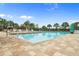 Outdoor community pool area with plenty of lounge chairs and a brick-paved deck at 8788 Fetterbush Ct, Brooksville, FL 34613