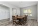 Bright dining room features a wood table with six chairs and wood floors at 8788 Fetterbush Ct, Brooksville, FL 34613