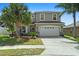Charming home with a two-car garage, well-maintained lawn, and mature palm trees at 8788 Fetterbush Ct, Brooksville, FL 34613