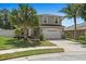 Inviting two-story home with manicured landscaping, mature palm trees, and a spacious two-car garage at 8788 Fetterbush Ct, Brooksville, FL 34613