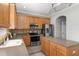 Modern kitchen with stainless steel appliances, an island, and stylish countertops at 8788 Fetterbush Ct, Brooksville, FL 34613