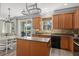 Charming kitchen with wood cabinets, an island, and access to the backyard at 8788 Fetterbush Ct, Brooksville, FL 34613