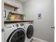 Functional laundry room featuring a modern washer and dryer at 8788 Fetterbush Ct, Brooksville, FL 34613