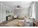 Comfortable living room with a sectional sofa, chair, and a large TV at 8788 Fetterbush Ct, Brooksville, FL 34613