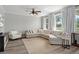 Spacious living room with a large sectional sofa and natural light at 8788 Fetterbush Ct, Brooksville, FL 34613