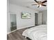 Main bedroom featuring hardwood floors, natural light, and a large mirror at 8788 Fetterbush Ct, Brooksville, FL 34613