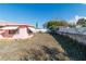 A view of the backyard showing a pink house and dry lawn at 8846 Tropical Palm Way, Port Richey, FL 34668