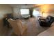 Cozy living room featuring neutral carpeting and a large window for natural light at 9005 Prosperity Ln, Port Richey, FL 34668