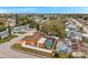 Aerial view of the home showing a screened-in pool area, fenced backyard, and the surrounding neighborhood at 9220 Saint Regis Ln, Port Richey, FL 34668