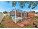 Lush backyard featuring a fully screened pool, seamlessly blending leisure with outdoor living at 9220 Saint Regis Ln, Port Richey, FL 34668