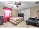 Bedroom with tile flooring, ceiling fan, curtained window, and sitting chair at 9220 Saint Regis Ln, Port Richey, FL 34668