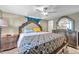 Bedroom featuring bed with ornate headboard, tile floors, and bright blue curtains at 9220 Saint Regis Ln, Port Richey, FL 34668