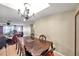 Classic dining room with a vintage chandelier and an open layout, perfect for Gathering meals and entertaining at 9220 Saint Regis Ln, Port Richey, FL 34668