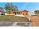 Charming single-story home with a unique orange and yellow garage door at 9220 Saint Regis Ln, Port Richey, FL 34668