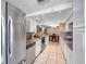 Kitchen showcasing stainless steel appliances, granite countertops, white cabinets and an open layout at 9220 Saint Regis Ln, Port Richey, FL 34668