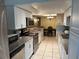 Modern kitchen featuring white cabinetry, granite countertops, and stainless steel appliances at 9220 Saint Regis Ln, Port Richey, FL 34668