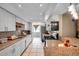 Open kitchen with granite counters, white cabinets, stainless appliances, and modern backsplash at 9220 Saint Regis Ln, Port Richey, FL 34668