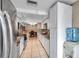 Kitchen view shows stainless steel appliances, granite countertops and a view of the dining area at 9220 Saint Regis Ln, Port Richey, FL 34668