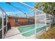 Screened-in pool with safety fence offers a secure and enjoyable outdoor living experience at 9220 Saint Regis Ln, Port Richey, FL 34668