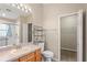 Bright bathroom features a walk-in shower, closet, and wood vanity with sink at 11082 Heathrow Ave, Spring Hill, FL 34609