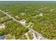 Aerial view showing the new construction single Gathering home in a densely wooded area at 11345 Thrasher Ave, Weeki Wachee, FL 34614