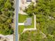 Aerial view shows a charming single-Gathering home in a verdant, tree-filled neighborhood at 11345 Thrasher Ave, Weeki Wachee, FL 34614