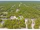 Aerial view of a single-Gathering home surrounded by vast green spaces and lush trees at 11345 Thrasher Ave, Weeki Wachee, FL 34614