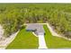 Aerial view of a charming single-Gathering home nestled in a lush, green landscape at 11345 Thrasher Ave, Weeki Wachee, FL 34614