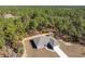 New construction home with gray roof, concrete driveway, and lawn in a beautiful wooded neighborhood at 11345 Thrasher Ave, Weeki Wachee, FL 34614