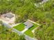 Aerial shot captures a single-Gathering house surrounded by verdant trees and lush greenery at 11345 Thrasher Ave, Weeki Wachee, FL 34614