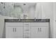 Bathroom featuring double sinks and a granite countertop with tile backsplash; great natural light at 11345 Thrasher Ave, Weeki Wachee, FL 34614