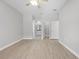 Spacious bedroom with wood-look tile flooring, neutral paint, and access to a bathroom and closet at 11345 Thrasher Ave, Weeki Wachee, FL 34614
