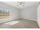 Bright bedroom featuring a large window providing natural light and a ceiling fan at 11345 Thrasher Ave, Weeki Wachee, FL 34614