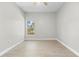 Cozy bedroom with wood-look flooring, a ceiling fan, and natural light from a window at 11345 Thrasher Ave, Weeki Wachee, FL 34614
