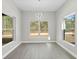 Well-lit dining room featuring neutral paint, tile flooring, and nature views through large windows at 11345 Thrasher Ave, Weeki Wachee, FL 34614