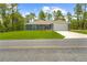 Charming single-story home with a well-maintained lawn and an attached two-car garage at 11345 Thrasher Ave, Weeki Wachee, FL 34614