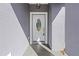 Close-up of a white front door with decorative glass and a modern light fixture at 11345 Thrasher Ave, Weeki Wachee, FL 34614