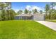 Well-maintained single-story home with a lush green lawn and attached two car garage at 11345 Thrasher Ave, Weeki Wachee, FL 34614