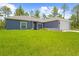 Charming single-story home with a well-maintained lawn and an attached two-car garage at 11345 Thrasher Ave, Weeki Wachee, FL 34614
