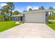 Exterior shot showcasing the home's garage, driveway, and clean architectural lines at 11345 Thrasher Ave, Weeki Wachee, FL 34614
