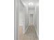 Bright hallway features wood-look tile flooring and neutral paint tones at 11345 Thrasher Ave, Weeki Wachee, FL 34614