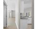 Open kitchen with white cabinetry and granite countertops offers a view into the rest of the house at 11345 Thrasher Ave, Weeki Wachee, FL 34614
