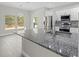 Kitchen island with granite countertops, stainless steel appliances, and bright lighting at 11345 Thrasher Ave, Weeki Wachee, FL 34614