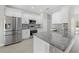 Modern kitchen featuring granite counters, stainless steel appliances, and bright white cabinetry at 11345 Thrasher Ave, Weeki Wachee, FL 34614