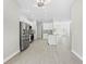 Open kitchen boasts stainless steel appliances, white cabinets, and an easy view of the living area at 11345 Thrasher Ave, Weeki Wachee, FL 34614